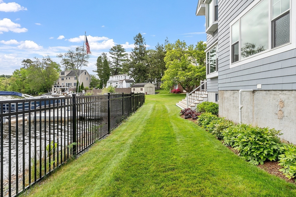 1 Colonial Road Lynnfield, MA 01940 - Photo 32 of 42 a view of a backyard with pathway