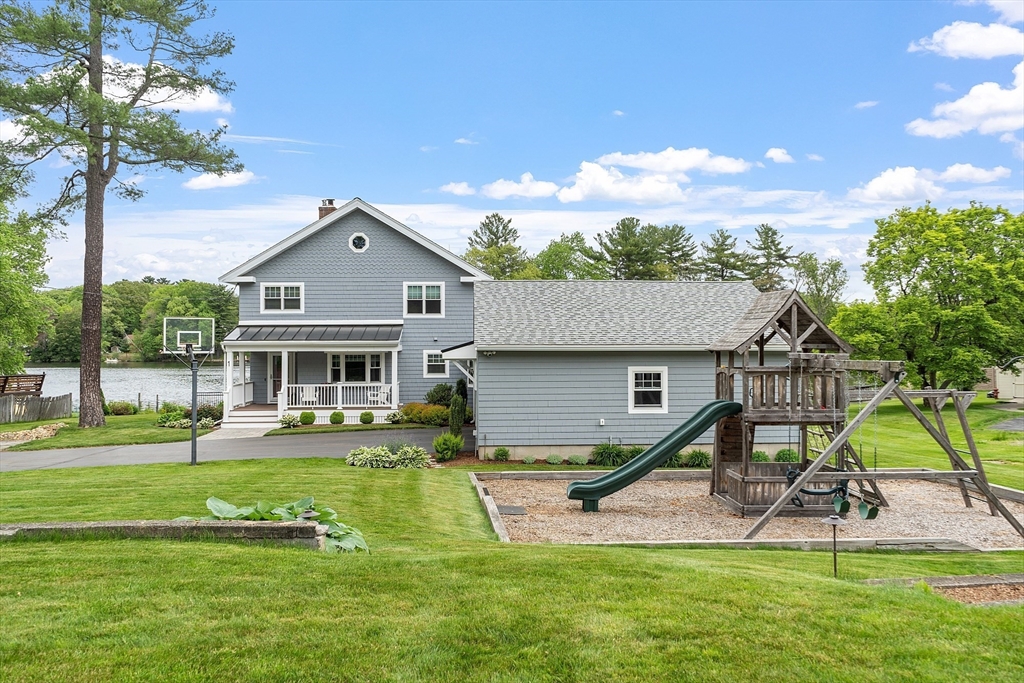 1 Colonial Road Lynnfield, MA 01940 - Photo 33 of 42 a front view of house with a garden and trees