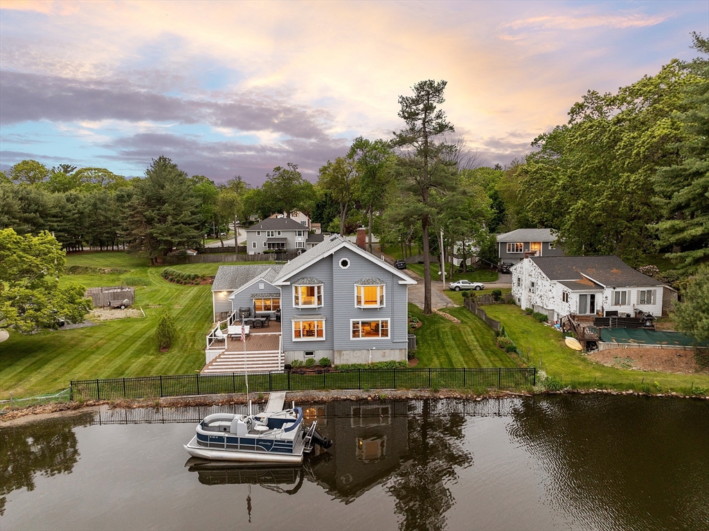 1 Colonial Road Lynnfield, MA 01940 - Photo 4 of 42 a front view of a house with a lake view