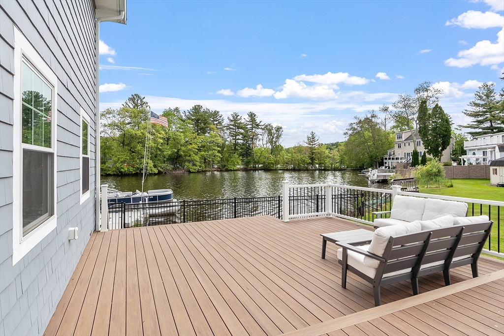 1 Colonial Road Lynnfield, MA 01940 - Photo 5 of 42 a view of a lake with outdoor seating