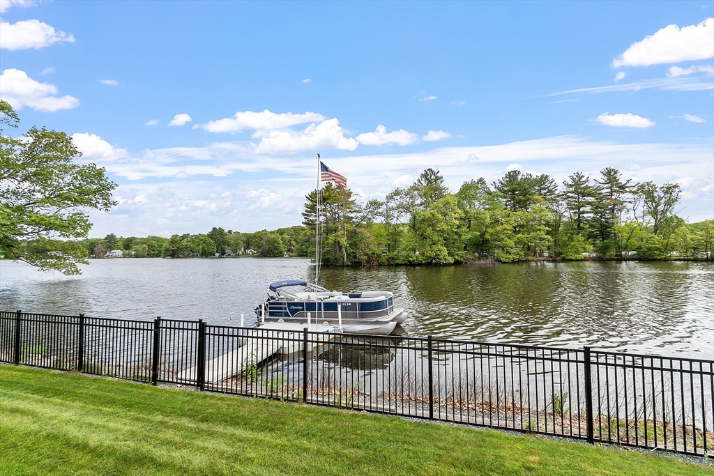 1 Colonial Road Lynnfield, MA 01940 - Photo 6 of 42 a view of a lake with houses in back