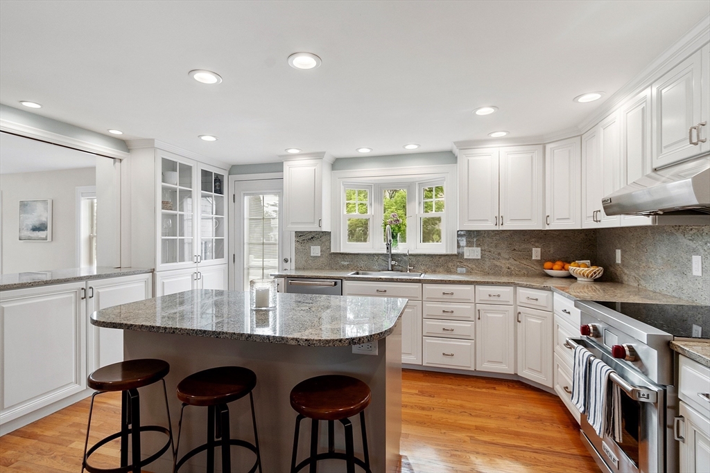 1 Colonial Road Lynnfield, MA 01940 - Photo 8 of 42 a kitchen with granite countertop white cabinets and stainless steel appliances