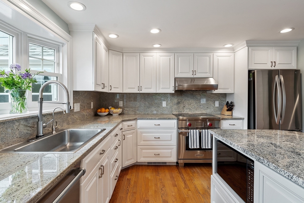 1 Colonial Road Lynnfield, MA 01940 - Photo 9 of 42 a kitchen with stainless steel appliances granite countertop a sink stove and refrigerator