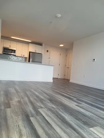 a view of a kitchen center island and wooden floor
