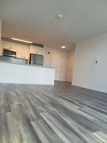 a view of a kitchen center island and wooden floor