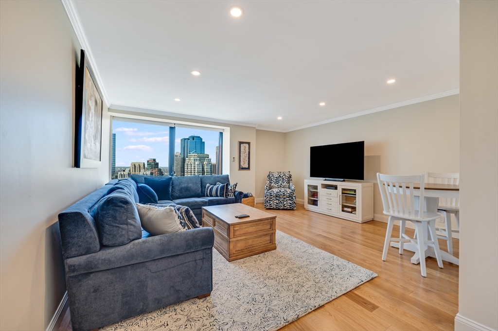 85 East India Row, Unit 34G Boston, MA 02110 - Photo 13 of 20 a living room with furniture and a flat screen tv