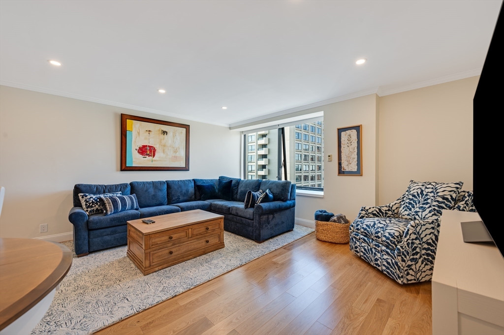 85 East India Row, Unit 34G Boston, MA 02110 - Photo 14 of 20 a living room with furniture or couch and a wooden floor