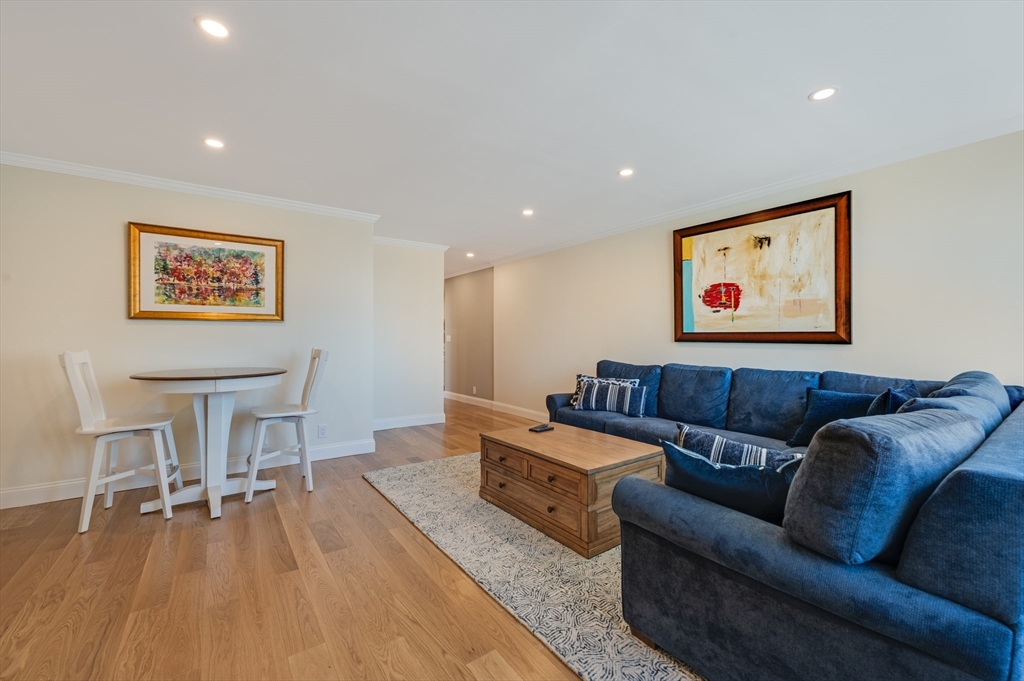 85 East India Row, Unit 34G Boston, MA 02110 - Photo 15 of 20 a living room with furniture and a wooden floor