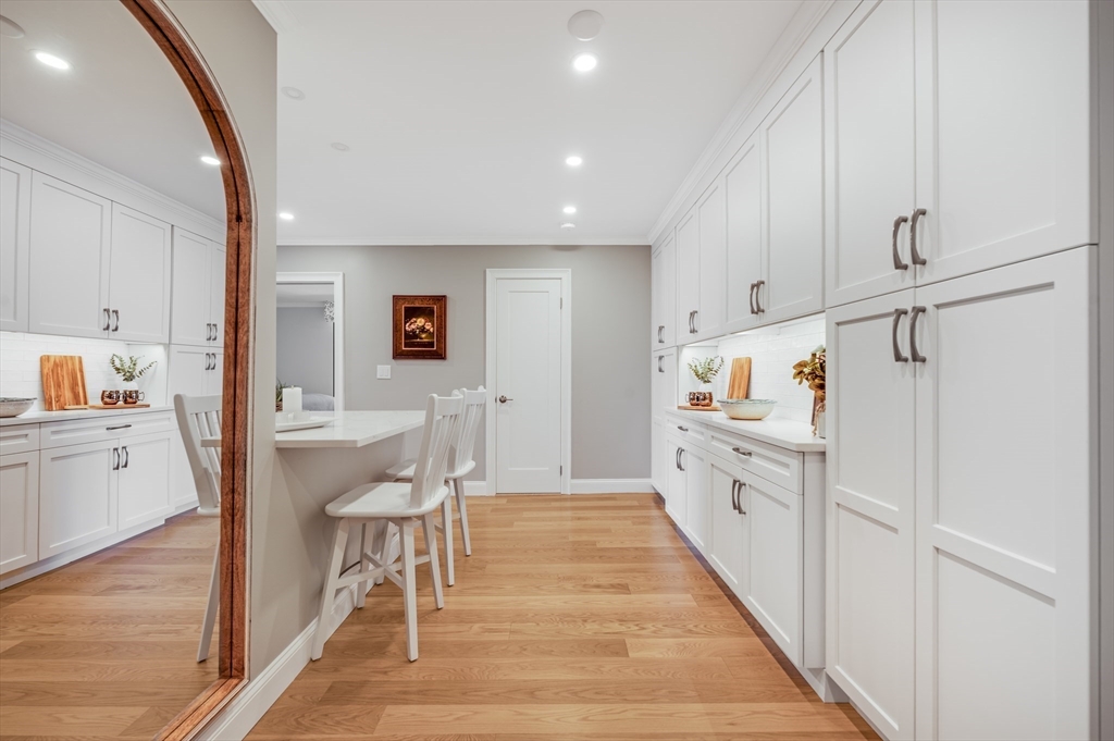 85 East India Row, Unit 34G Boston, MA 02110 - Photo 3 of 20 a kitchen with white cabinets and chairs