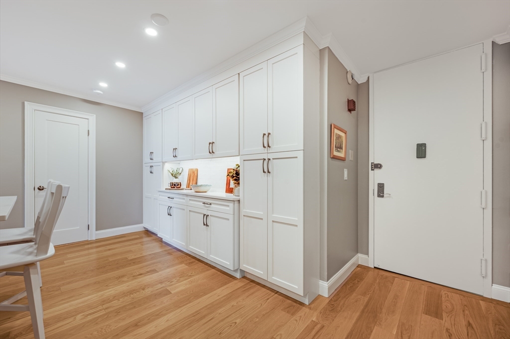 85 East India Row, Unit 34G Boston, MA 02110 - Photo 4 of 20 a room with white cabinets and wooden floor