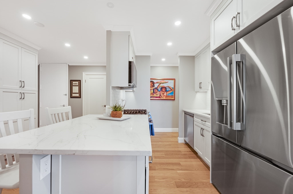 85 East India Row, Unit 34G Boston, MA 02110 - Photo 7 of 20 a kitchen with stainless steel appliances a refrigerator and a stove
