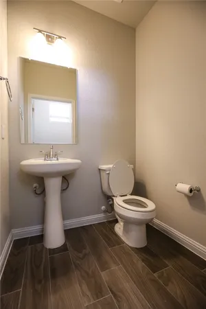 a bathroom with a sink toilet and a mirror