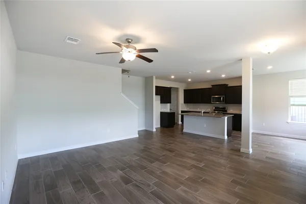 a view of kitchen with kitchen island stainless steel appliances refrigerator stove and microwave