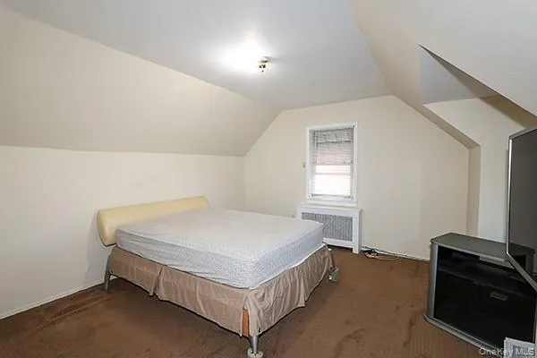 a bed sitting in a room next to a window