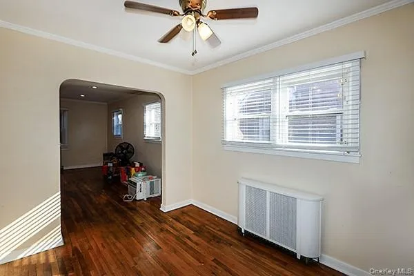 a view of a room with wooden floor and windows