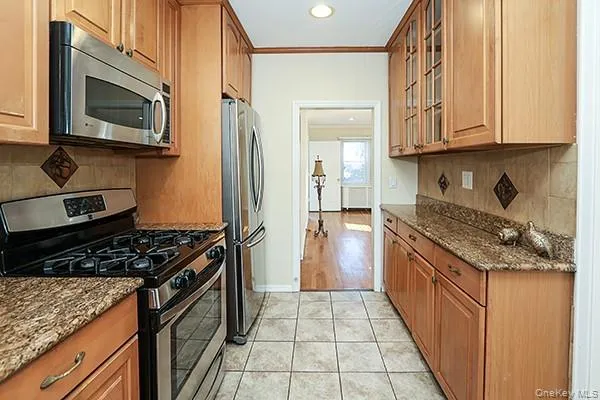 a kitchen with stainless steel appliances granite countertop a stove and a refrigerator