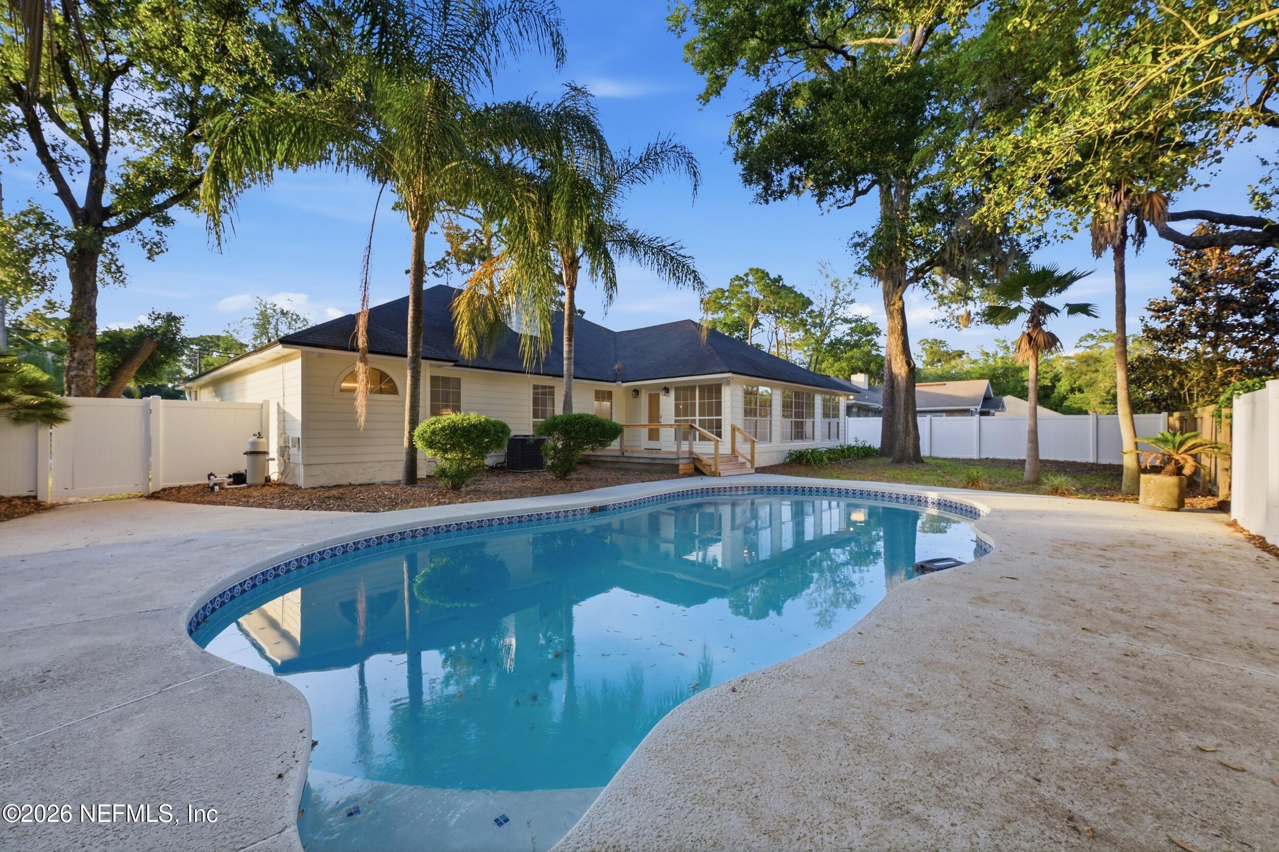 3286 Marbon Road Jacksonville, FL 32223 - Photo 33 of 36 a view of a swimming pool with a patio