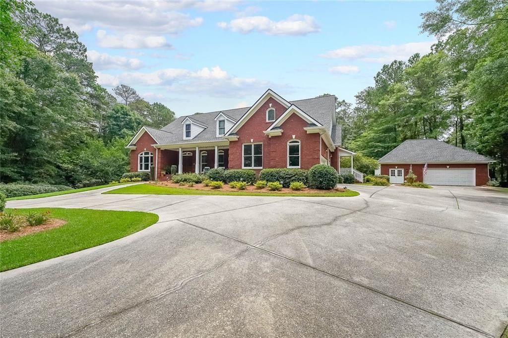 a front view of house with yard and green space