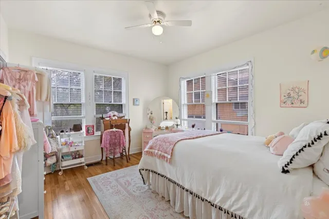a bedroom with bed and a large window