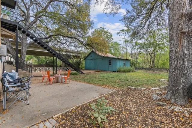 a view of a house with backyard and sitting area
