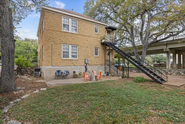a view of a house with backyard porch and sitting area