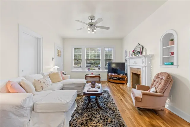 a living room with furniture fireplace and flat screen tv