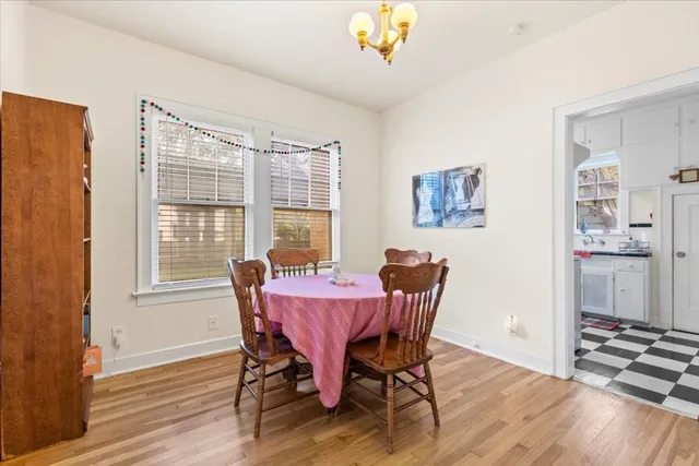a view of a dining room with furniture window and wooden floor