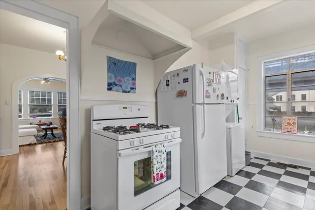 a kitchen with stainless steel appliances granite countertop a refrigerator and a stove top oven