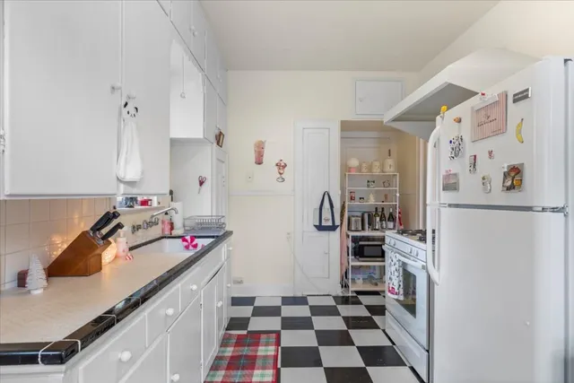 a kitchen with a refrigerator and a sink