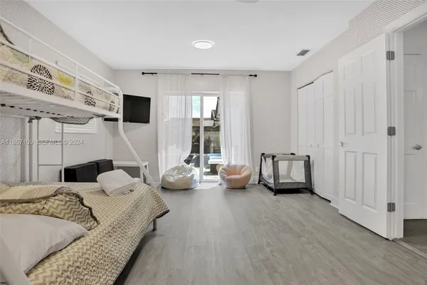 a bedroom with furniture and a large window