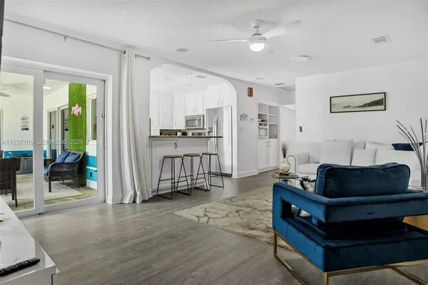 a living room with furniture and wooden floor
