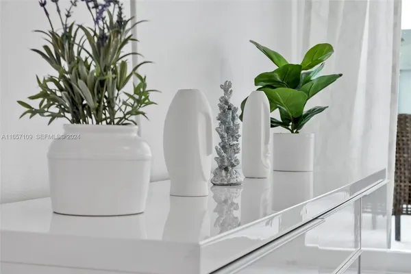 a vase of flowers sitting on a shelf
