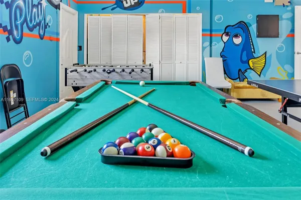 a room with pool table and painted walls