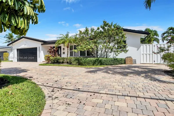 a front view of a house with a yard and a garage