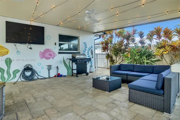 a dining room with furniture and a flat screen tv
