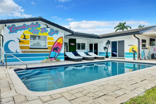 a swimming pool with outdoor seating and yard