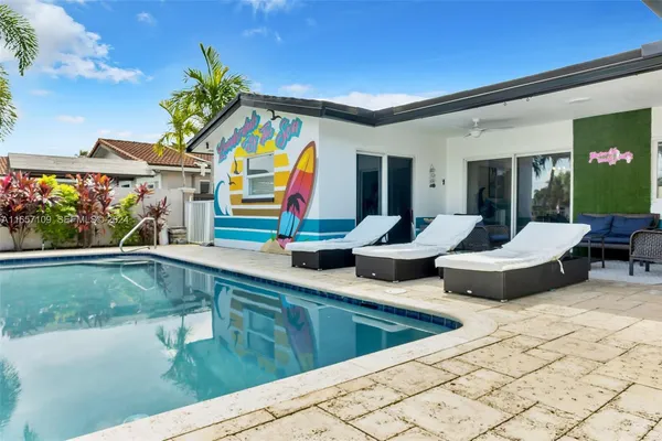 a view of a house with backyard porch and sitting area