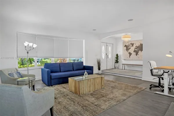 a living room with furniture and a rug