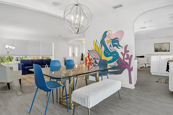 a view of a dining room with furniture and wooden floor