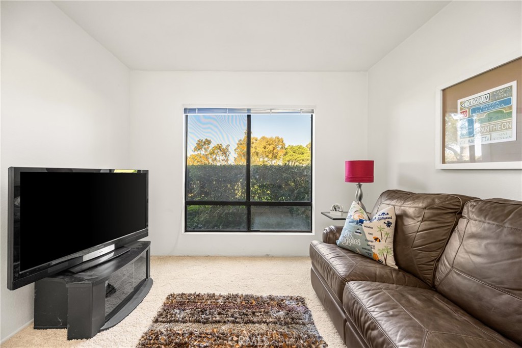 18 Solana Irvine, CA 92612 - Photo 31 of 55 a living room with furniture and a flat screen tv
