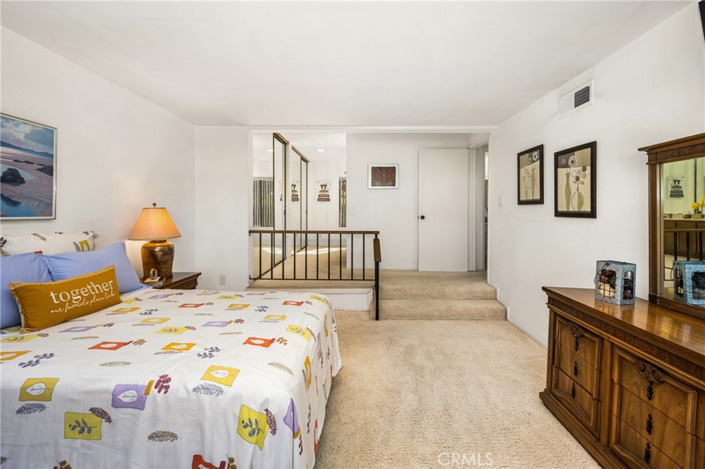 18 Solana Irvine, CA 92612 - Photo 35 of 55 a bedroom with a bed a couch and a flat tv screen on the dresser