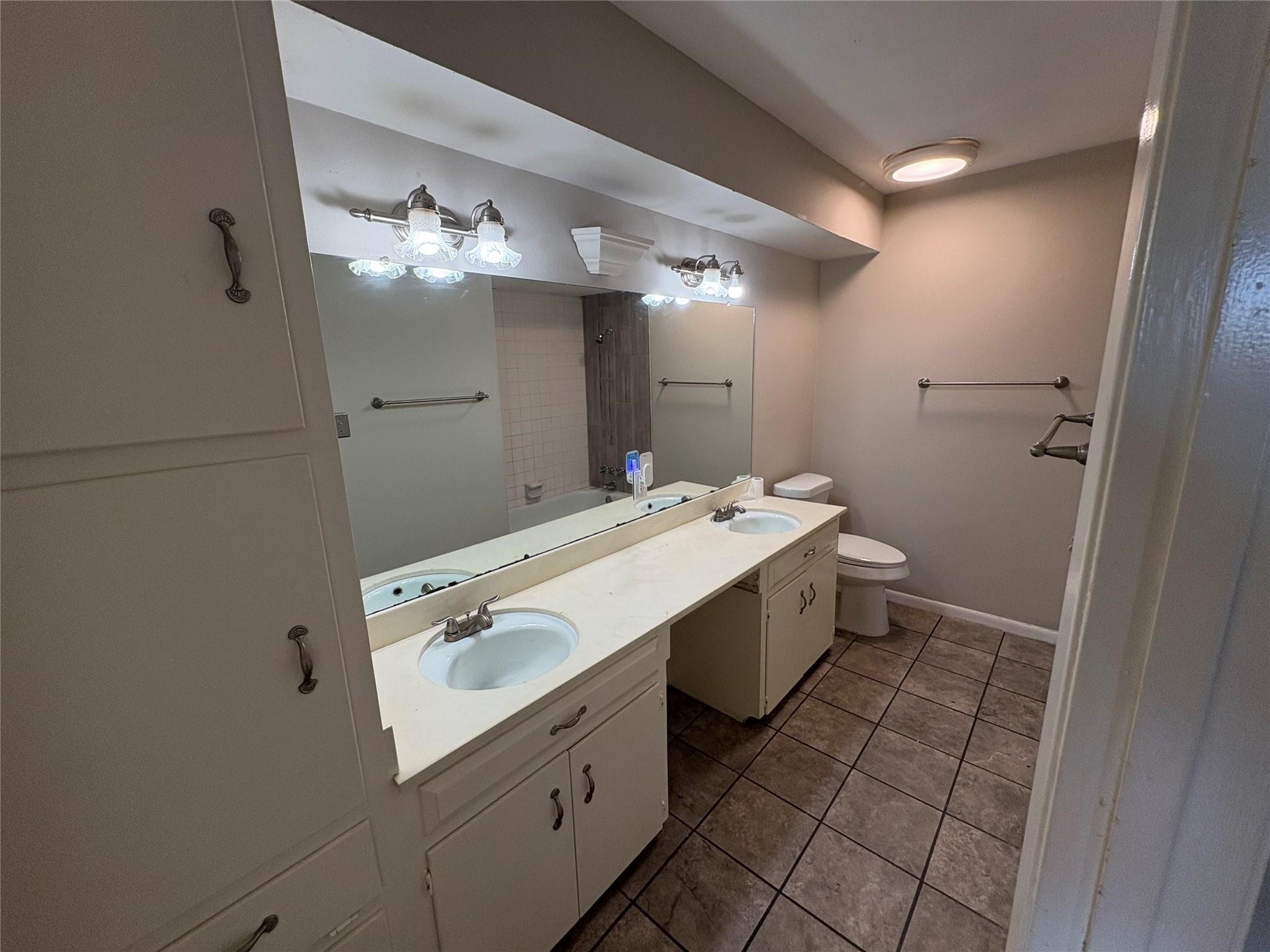 17159 Beaver Springs Drive, Unit 13 Houston, TX 77090 - Photo 9 of 14 a spacious bathroom with a double vanity sink and a mirror