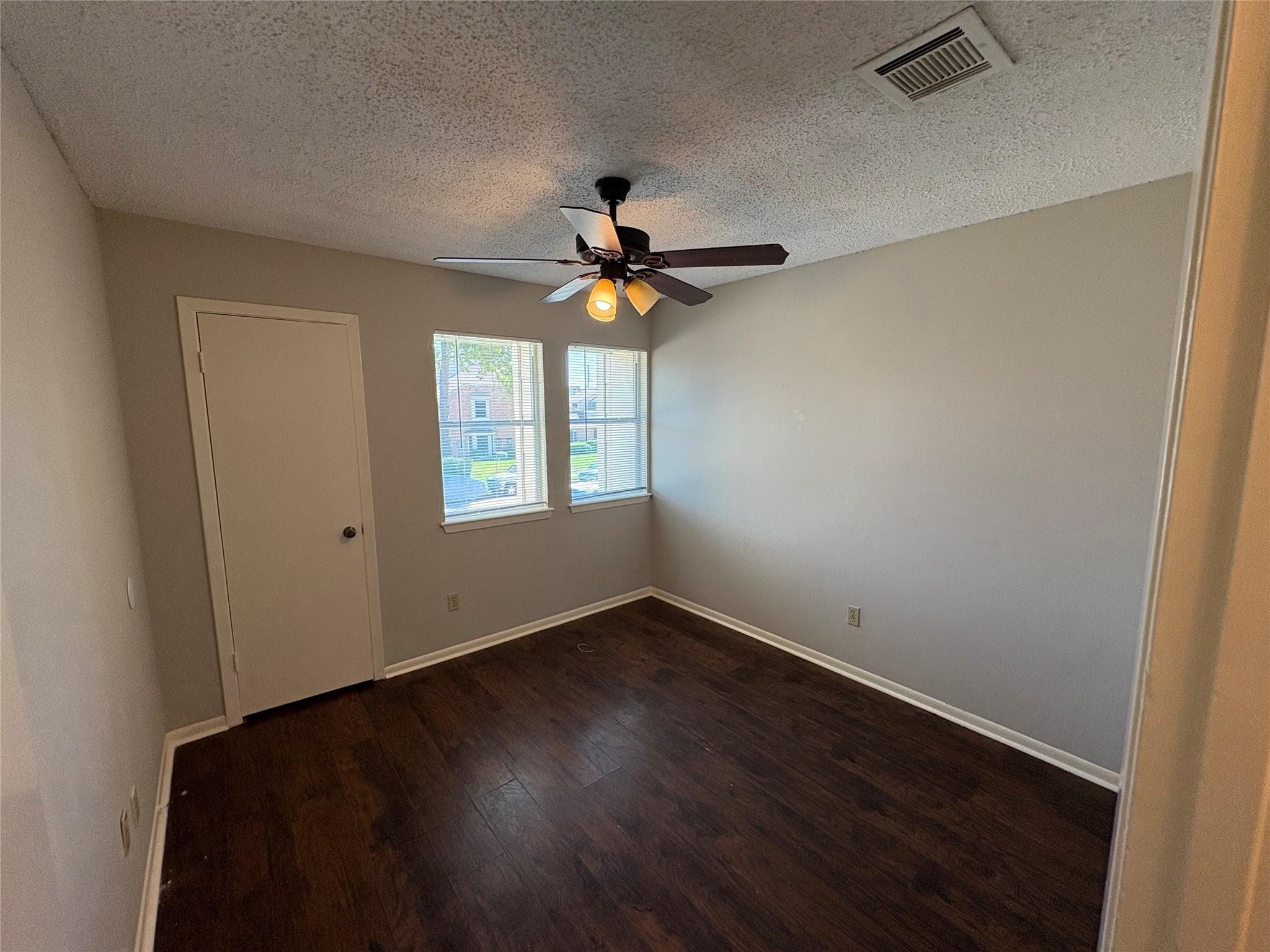 17159 Beaver Springs Drive, Unit 13 Houston, TX 77090 - Photo 10 of 14 an empty room with wooden floor and windows