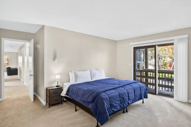 a spacious bedroom with a bed and a large window