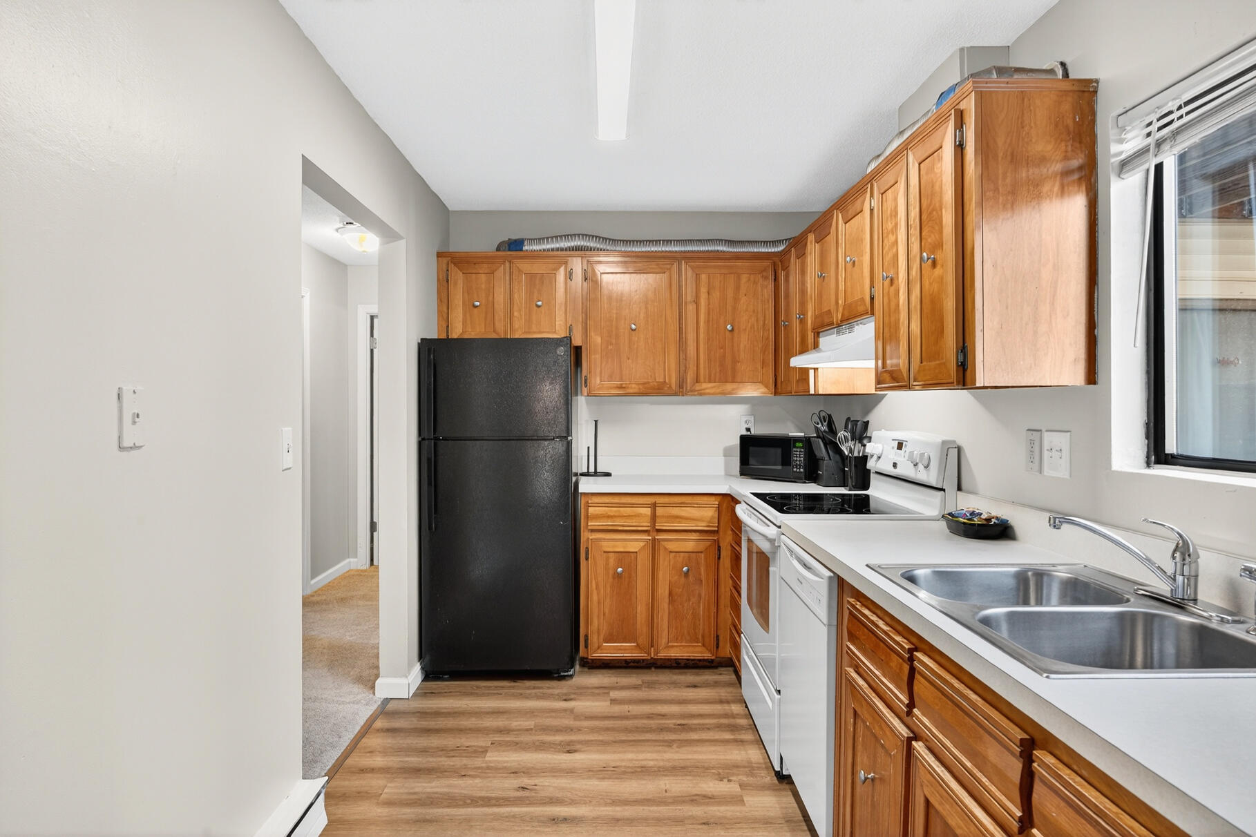 800 Bearses Way, Unit 1NE Hyannis, MA 02601 - Photo 2 of 27 a kitchen with a refrigerator and a sink