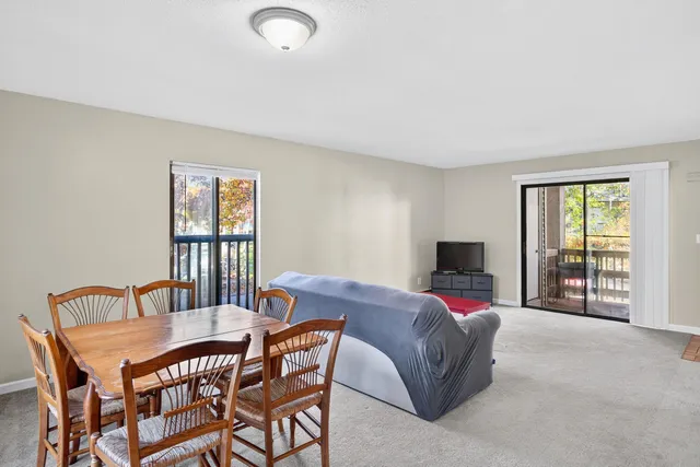 a view of a livingroom with furniture and a window