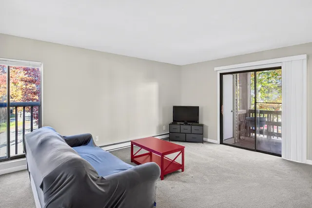 a bedroom with furniture and a flat screen tv