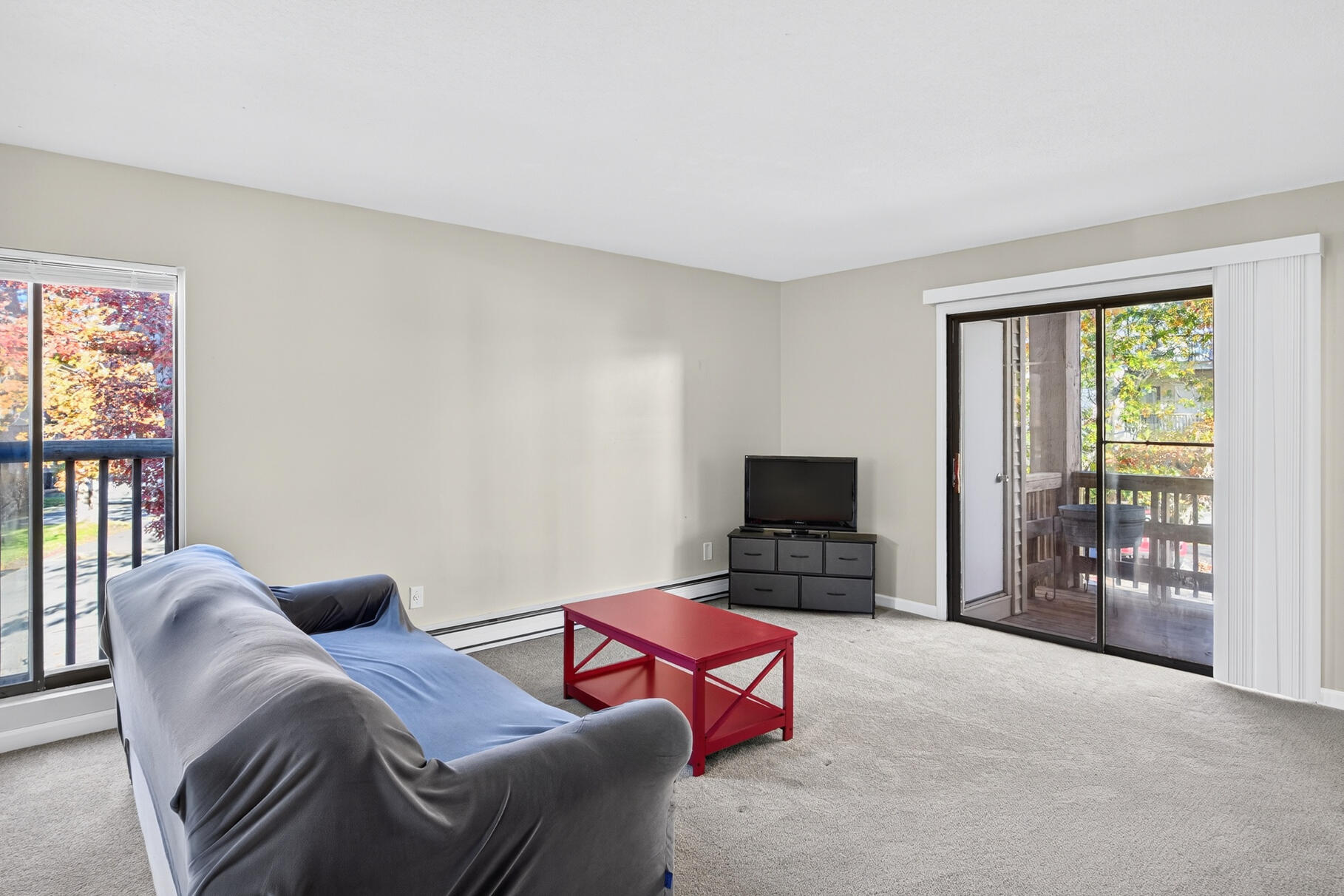 800 Bearses Way, Unit 1NE Hyannis, MA 02601 - Photo 9 of 27 a bedroom with furniture and a flat screen tv