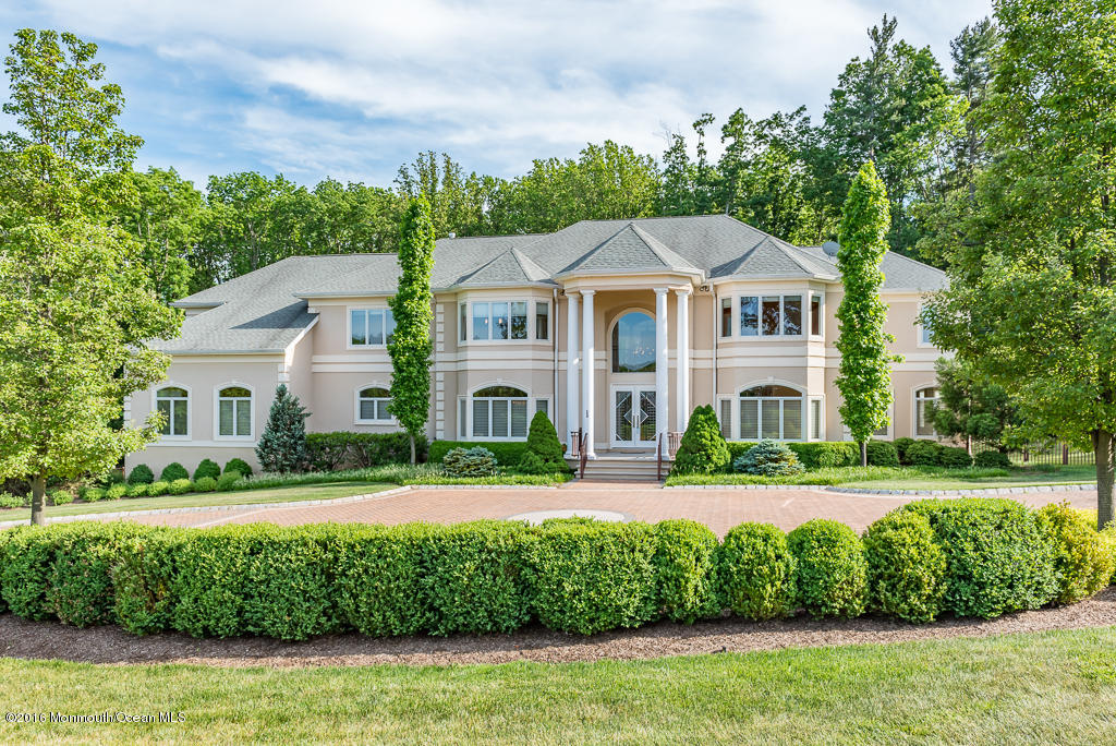 500 Farm Bridge Road Marlboro, NJ 07746 - Photo 1 of 57 a front view of a house with a yard