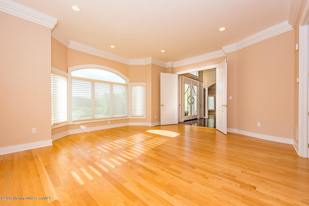 500 Farm Bridge Road Marlboro, NJ 07746 - Photo 14 of 57 a view of an empty room with wooden floor and windows